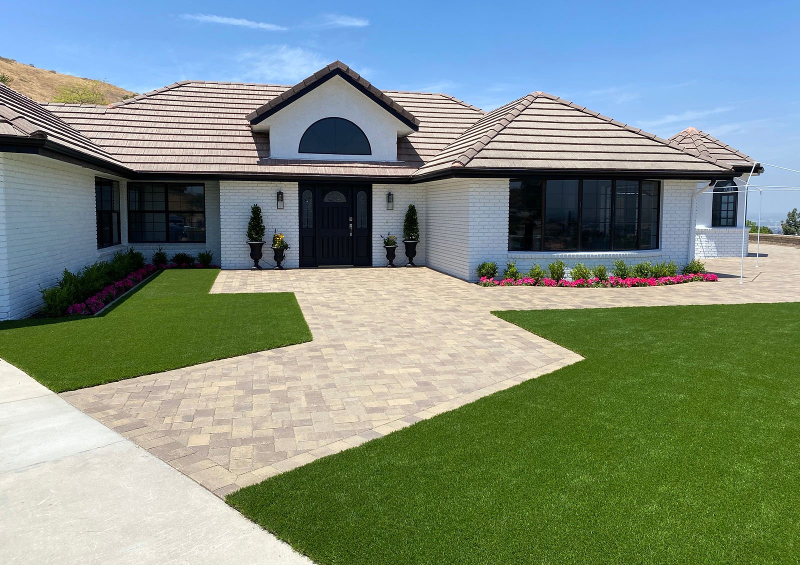 Paver driveway and turf front yard installed by Newline Concrete and Pavers